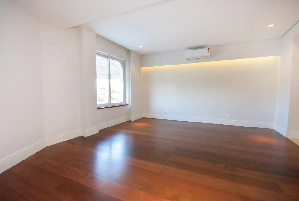 Apartment bedroom with a window and wood flooring