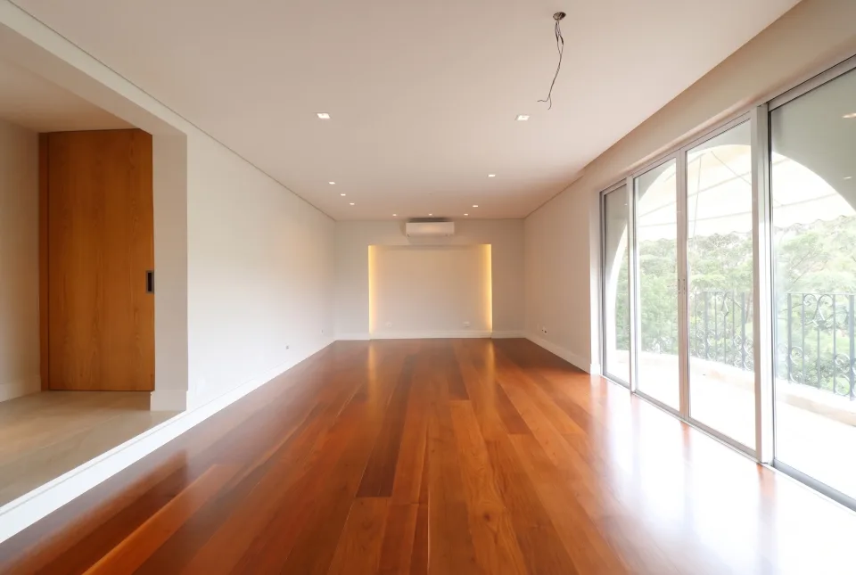 Apartment living room with wood flooring and large windows